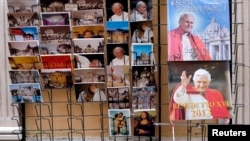 Postcards and calendars are displayed outside a shop at the Vatican, February 12, 2013.