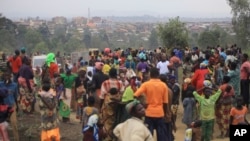 FILE - People who fled from their homes following attacks by assailants take refuge at a camp for displaced people in Bunia, Eastern Congo.