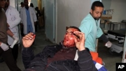 Palestinian doctors bring a wounded man for treatment following an Israeli airstrike in Rafah, southern Gaza Strip, Saturday, March 10, 2012
