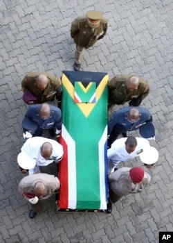 The flag-draped casket carrying the remains of anti-apartheid icon Winnie Madikizela-Mandela arrives at the Orlando Stadium in Soweto, South Africa, April 14, 2018.