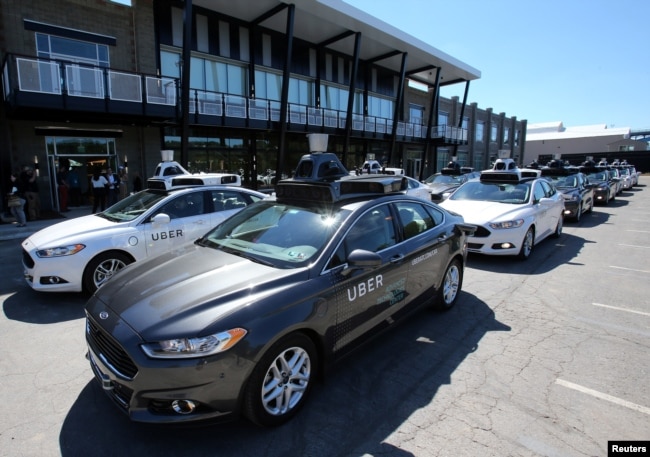 A fleet of Uber's Ford Fusion self driving cars are shown during a demonstration of self-driving automotive technology in Pittsburgh, Pennsylvania, Sept. 13, 2016.
