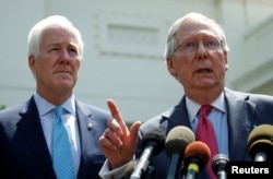 Senate Majority Leader Mitch McConnnell, right, and Senate Majority Whip John Cornyn speak to reporters after U.S. President Donald Trump's meeting with Senate Republicans to discuss health care at the White House in Washington, July 19, 2017.