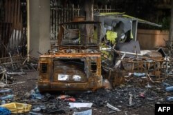 A burned car and bulding which were set on fire by a mob during the violence after the assasination of Oromo's pop singer Hachalu Hundessa are seen in Shashamene, Ethiopia, on July 12, 2020.