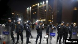 Turkish riot police stand guard in front of the Justice Palace in Istanbul. Turkish prosecutor Mehmet Selim Kiraz died during surgery for gunshot wounds. Two members of a banned leftist group, the Revolutionary People's Liberation Party, were also killed, March 31, 2015.