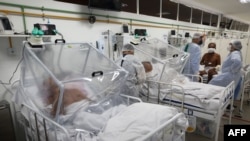 Health workers and patients are shown inside the Intensive Care Unit for COVID-19 of the Gilberto Novaes Hospital in Manaus, Brazil, on May 20, 2020.