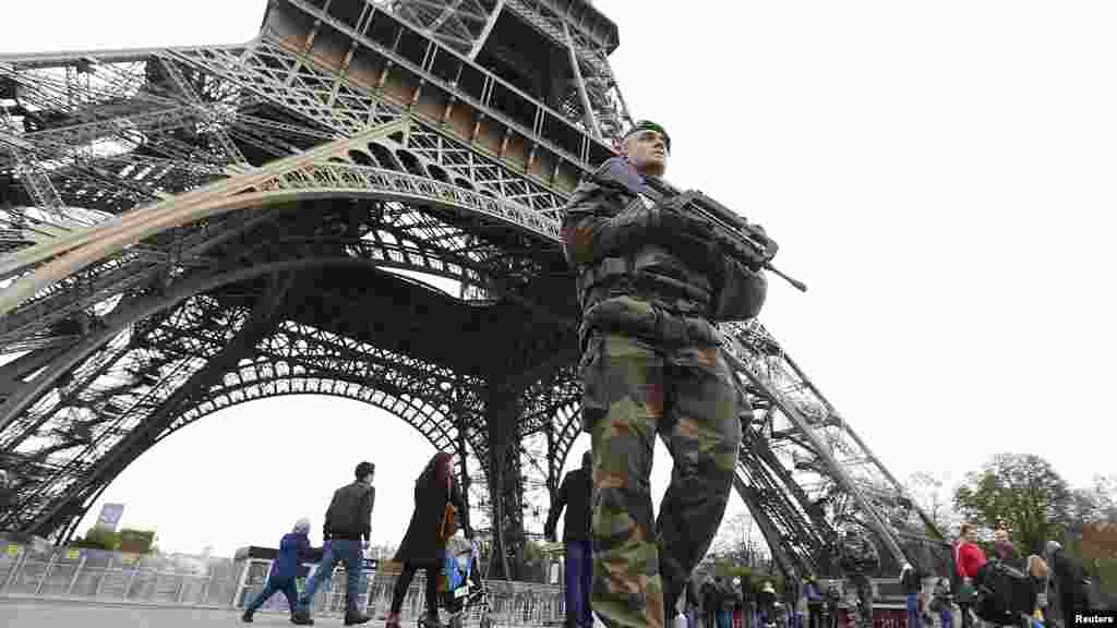 French military patrol near the Eiffel Tower the day after a series of deadly attacks in Paris, Nov. 14, 2015. 