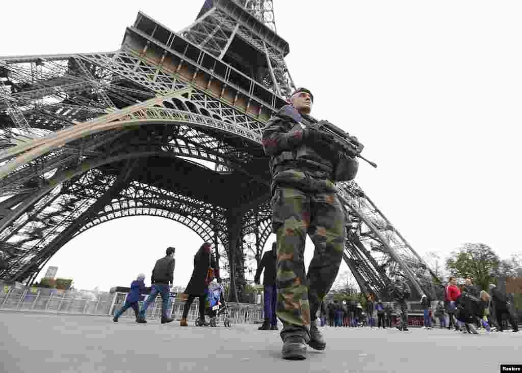 French military patrol near the Eiffel Tower the day after a series of deadly attacks in Paris, Nov. 14, 2015. 