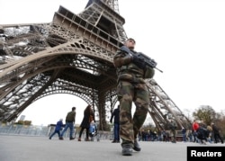 French military patrol near the Eiffel Tower the day after a series of deadly attacks in Paris, Nov. 14, 2015.