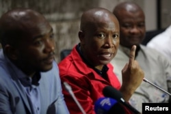 FILE - Julius Malema, leader of the opposition Economic Freedom Fighters (EFF) party, speaks during a media briefing at Parliament in Cape Town, South Africa, Feb. 12, 2018.