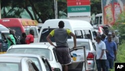 Motorists wait in a fuel queue in the capital Harare, Friday, Jan. 11, 2019. Zimbabwe's president has more than doubled the price of gasoline, hoping the increase will end severe shortages that are fueling public anger. 