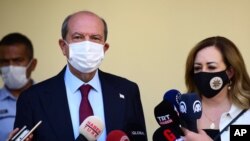 Ersin Tatar candidate and prime minister of a self-declared Turkish Cypriot state recognized only by Turkey with his wife Sibel Tatar speak to the media in the Turkish occupied area in the north part of the divided capital Nicosia, Oct. 18, 2020.