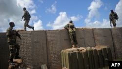 FILE - Somali soldiers patrol at the Sanguuni military base, about 450 km south of Mogadishu, Somalia, June 13, 2018.