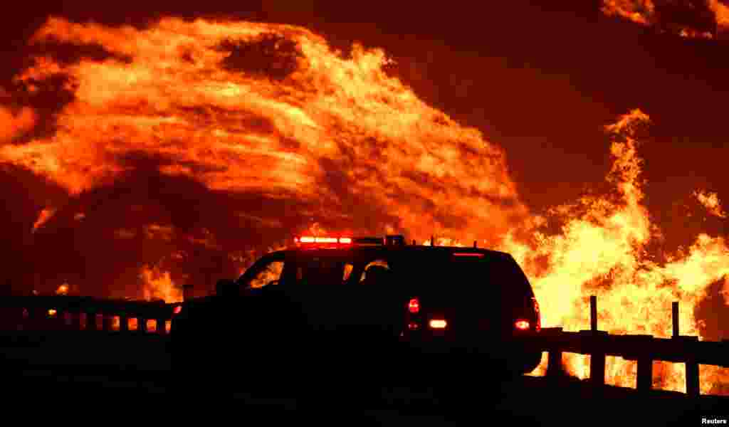 A wind-driven wildfire burns in Canyon Country, north of Los Angeles, California.