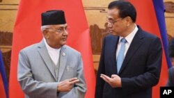 རྒྱ་ནག་དང་བལ་ཡུལ་གྱིས་གྲོས་མཐུན་༡༤་ལ་མིང་རྟགས་བཀོད་པ།