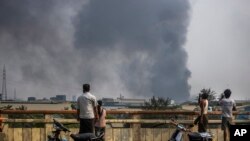 APTOPIX Myanmar China Torched Factories