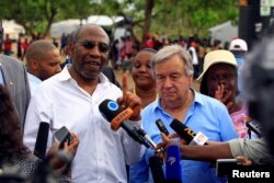 FILE - UN Secretary General Antonio Guterres (L) and Uganda's Prime Minister Ruhakana Rugunda address the media after a tour of Imvepi, where south Sudanese refugees are settled, in northern Uganda, June 22, 2017.