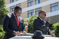 Lazarus Chakwera (L), the president for Malawi’s main opposition Party, the Malawi Congress Party, and his running mate, Saulos Klaus Chilima (R), gesture while they leave the Mount Soche Hotel in Blantyre, May 6, 2020.