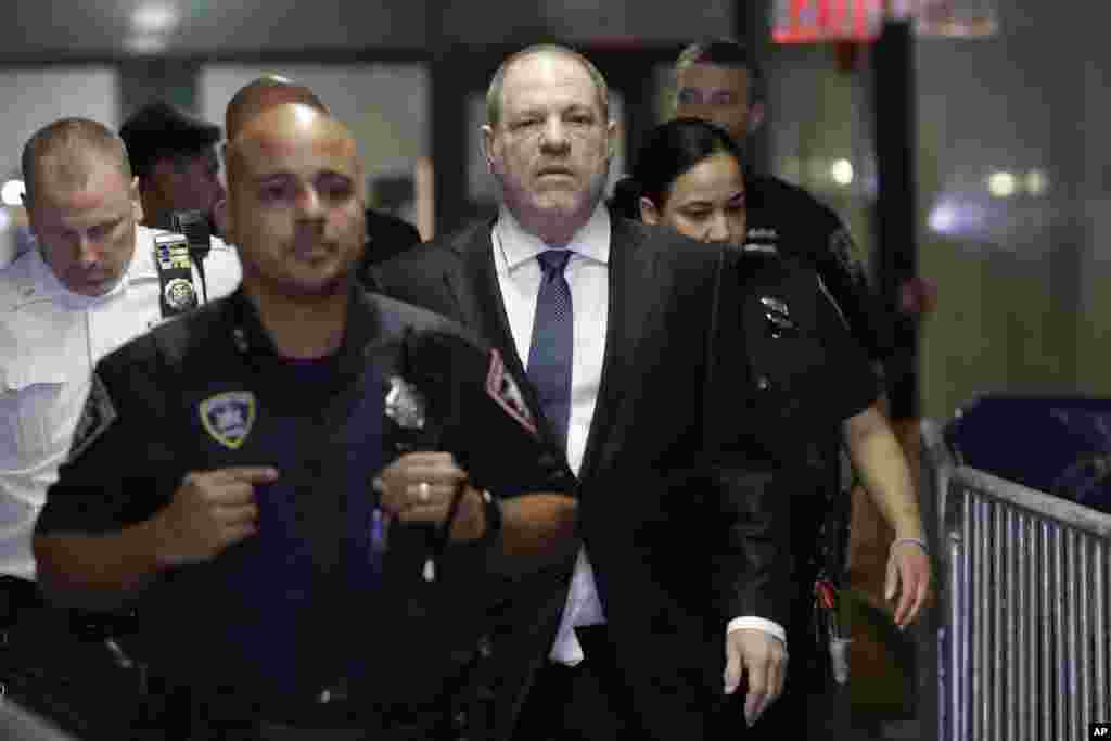 Harvey Weinstein, center, enters State Supreme Court in New York. Manhattan&#39;s district attorney dropped part of the criminal sexual assault case against the former film producer after evidence emerged that cast doubt on the account one of his three accusers provided to the grand jury.