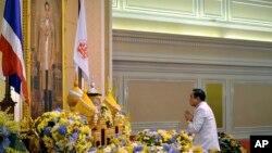 Tướng Prayuth Chan-ocha trước chân dung của Quốc vương Thái Lan Bhumibol Adulyadej sau lễ tuyên đọc một chiếu chỉ của Hoàng gia bổ nhiệm ông làm thủ tướng thứ 29 của vương quốc này.