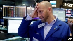 Specialist Meric Greenbaum works at his post on the floor of the New York Stock Exchange, June 24, 2016. 