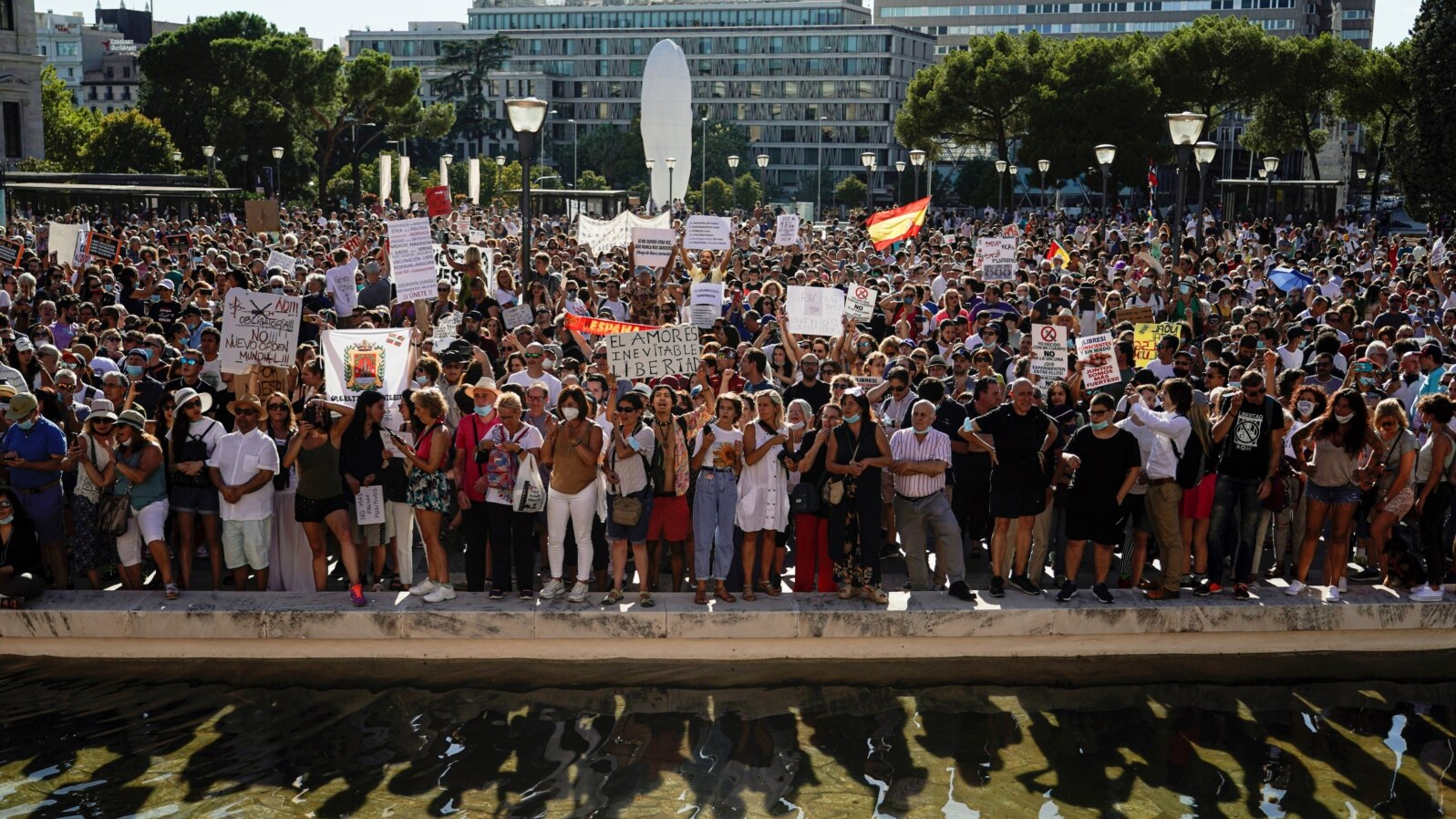 People take part in a protest against the use of protective masks amid the coronavirus pandemic, in Madrid, Spain, Aug. 16, 2020.