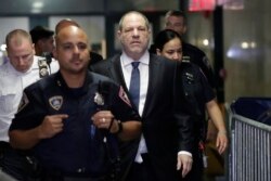 FILE - Harvey Weinstein, center, enters State Supreme Court in New York, Oct. 11, 2018.