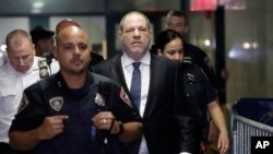 FILE - Harvey Weinstein, center, enters State Supreme Court in New York, Oct. 11, 2018.