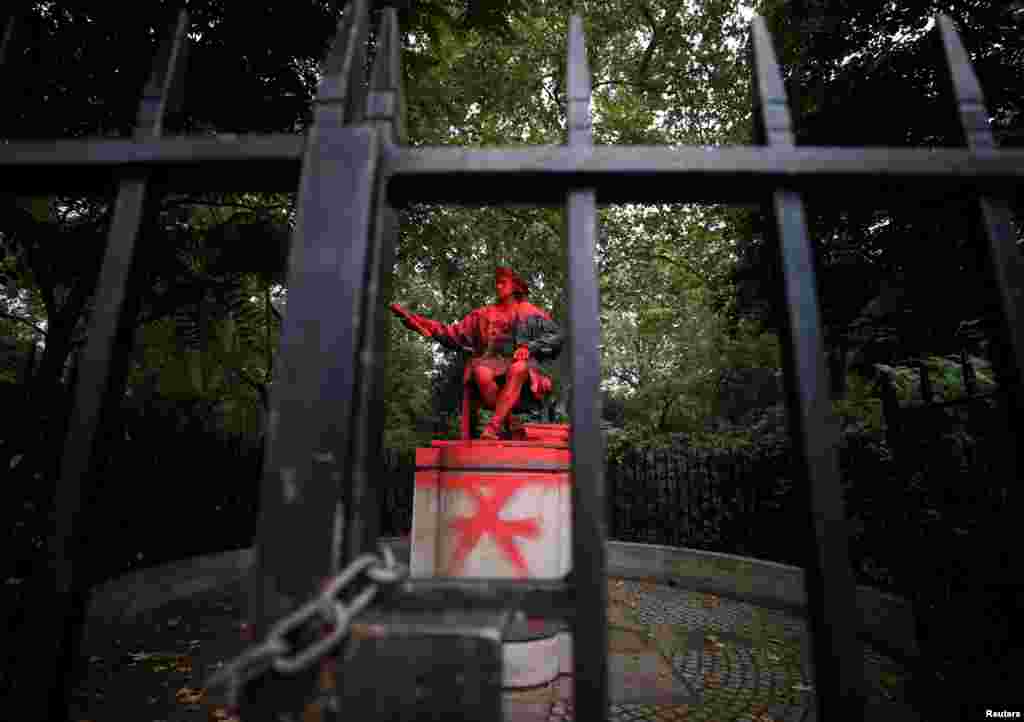 A vandalized statue of Christopher Columbus is seen in London, Britain.