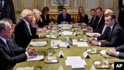 French President Emmanuel Macron, right, meets with US businessman Michael Bloomberg, left, Microsoft co-founder Bill Gates, British entrepreneur Sir Richard Branson, third left, and other philanthropists at the Elysee Palace in Paris, Dec. 12,