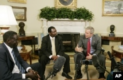 President Bush, second right, meets 2006 Democracy Award winners, from left to right: Alfred Taban of Sudan, Reginald Matchaba-Hove of Zimbabwe, and Zainab Bangura of Sierra Leone, in the Oval Office of the White House, June 27, 2006.