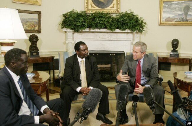 President Bush, second right, meets 2006 Democracy Award winners, from left to right: Alfred Taban of Sudan, Reginald Matchaba-Hove of Zimbabwe, and Zainab Bangura of Sierra Leone, in the Oval Office of the White House, June 27, 2006.