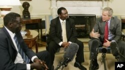 FILE - President George W. Bush, right, meets 2006 Democracy Award winners Alfred Taban of Sudan, left, and Reginald Matchaba-Hove of Zimbabwe, at the White House, June 27, 2006.