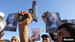 Protesters, mainly Houthi supporters, hold posters showing the late Hamas leader Yahya Sinwar as they rally to show support to Lebanon&#39;s Hezbollah and Palestinians in the Gaza Strip, in Sanaa, Yemen.