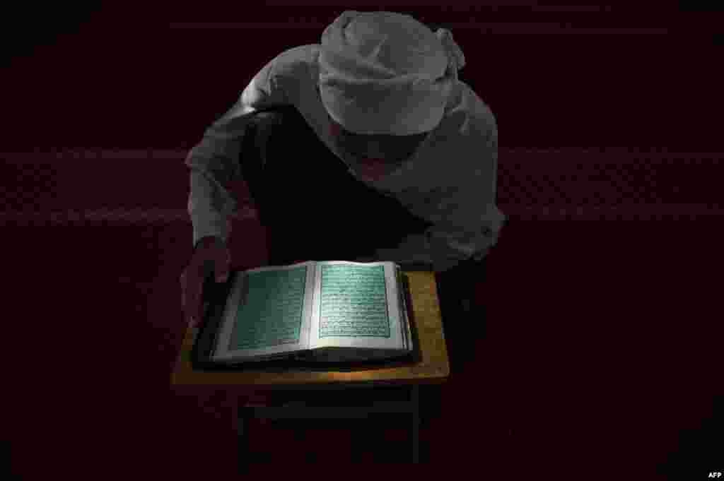 A Malaysian religious student reads the Koran at a school during the Muslim holy fasting month of Ramadan in Hulu Langat, near Kuala Lumpur.