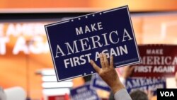 FILE - Delegates hold "Make America First Again" posters on the Republican National Convention floor in Cleveland, Ohio, July 20, 2016. (Photo: Ali Shaker / VOA)