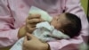 This photo taken on Jan. 19, 2019, shows a member of the medical staff taking care of a new born baby at a hospital in Fuyang in China's eastern Anhui province.