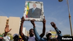 FILE—Supporters of Senegal's president Macky Sall march in support of him after the postponement of the February 25 presidential election, in Dakar, Senegal, February 24, 2024. 