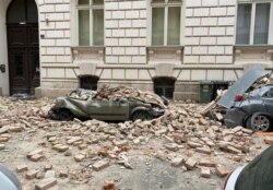 A car is crushed by falling debris after an earthquake in Zagreb, Croatia, March 22, 2020.