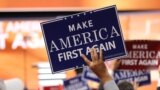 Delegates hold "Make America First Again" posters on the Republican National Convention floor in Cleveland, Ohio, July 20, 2016. (Photo: Ali Shaker / VOA) 