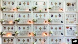 Candles are lit on a memorial wall during an anniversary memorial service to remember those who died when Ethiopian Airlines flight ET302, a Boeing 737 Max, crashed on March 10, 2019, at the Holy Trinity Cathedral in Addis Ababa, Ethiopia March 8, 2020.