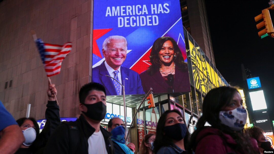 People celebrate media announcing that Democratic U.S. presidential nominee Joe Biden has won the 2020 U.S. presidential election, at Times Square in New York City, U.S. November 7, 2020. REUTERS/Jeenah Moon