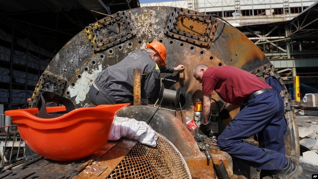 Workers repair part of a damaged thermal power plant, one of the country's largest, recently destroyed by Russian missiles near Kharkiv, Ukraine, on April 12, 2024.