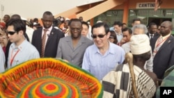 Taiwan's President Ma Ying-jeou (C) accompanied by Burkina Faso's Prime Minister Luc Adolph Tiao visits the vocational training center of reference (Centre de formation professionnelle de reference de Ziniare (CFPR-Z)) in Ziniare, 35kms of Ouagadougou on 