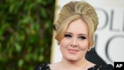 FILE - Adele arrives at the 70th Annual Golden Globe Awards at the Beverly Hilton Hotel in Beverly Hills, California. 