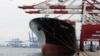 FILE - Containers are loaded onto a cargo ship at the Tianjin port in China. 