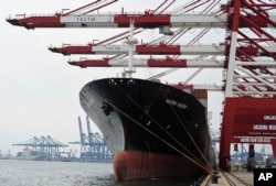 FILE - Containers are loaded onto a cargo ship at the Tianjin port in China. A Brookings Institution analyst said in late 2016 that if the U.S. doesn't take the lead "in writing the rules for the economy of East Asia, the Chinese will, and we are not going to like the outcome."