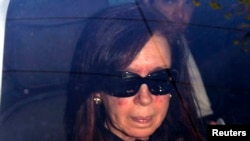FILE - Argentina's President Cristina Fernandez is seen sitting in a car as she arrives at a hospital in Buenos Aires October 7, 2013.