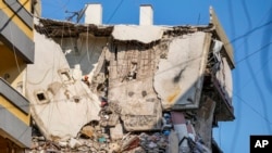 A rescuer searches for survivors in a building that was hit by an Israeli airstrike in Beirut's southern suburb, Sept. 24, 2024.