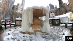 The Josephine Shaw Lowell Fountain in Bryant Park in New York remains frozen, Feb. 20, 2015. 