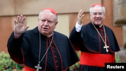 Mexican Cardinals Juan Sandoval Iniguez (L) and Josz Francisco Robles Ortega (R) wave as they arrive at a meeting at the Synod Hall in the Vatican March 7, 2013.